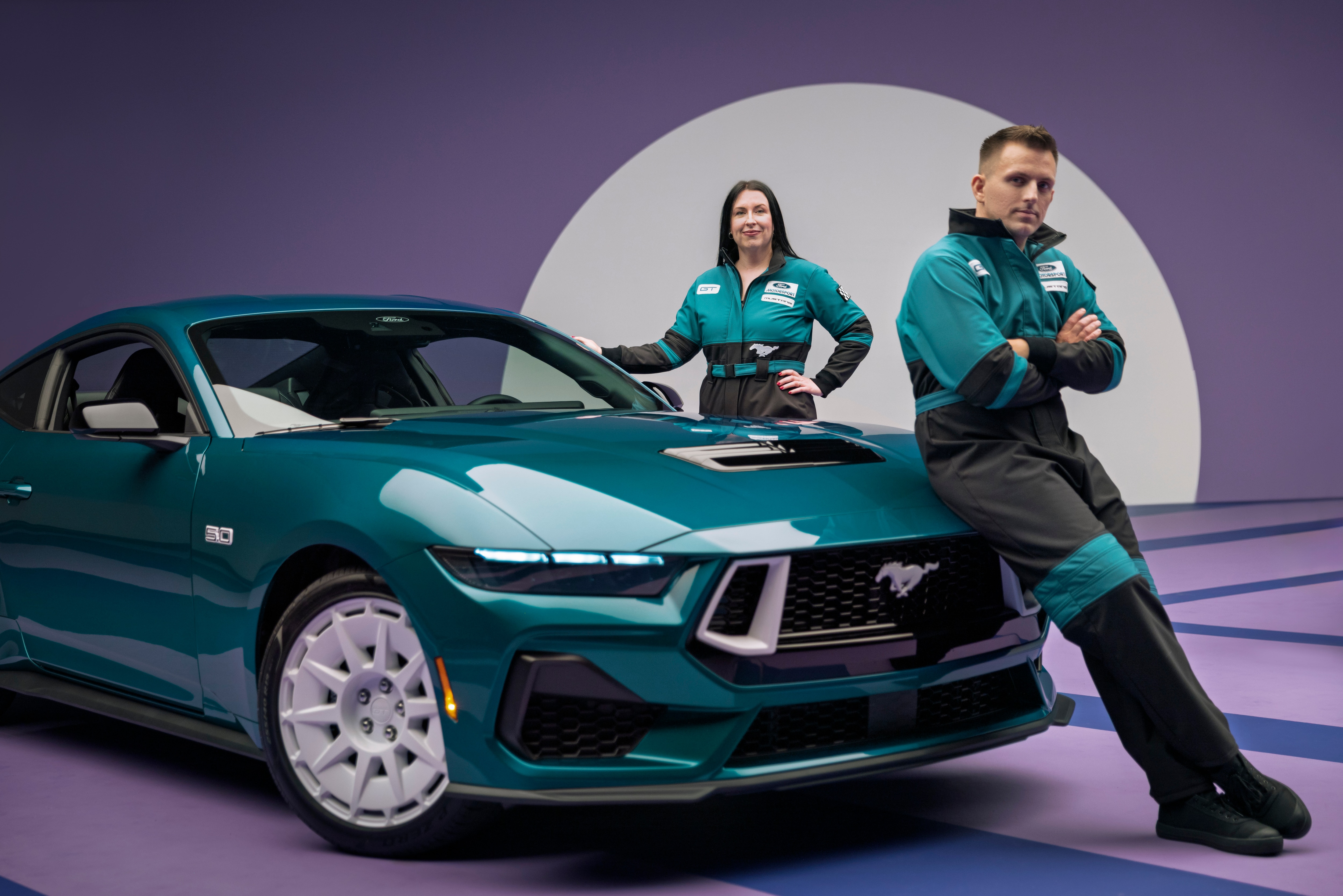 Designers Kristen Keenan and Stefan Taylor alongside the 2026 Mustang FX Package. Preproduction model shown with optional equipment and extra cost color.